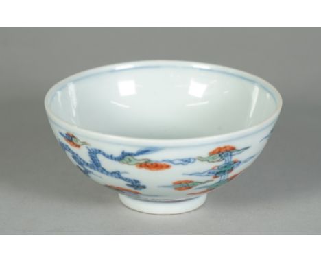 A small Chinese porcelain bowl. blue six character Yongzheng mark but later, painted in doucai style with two dragons amongst