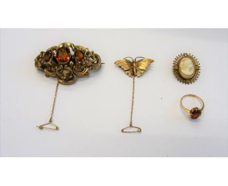 A gold ring, claw set with an oval cut citrine, ring size O, a Victorian gold and citrine brooch, in a scroll pierced openwor