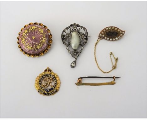 A gold brooch, glazed with an oval hair locket compartment to the centre, in a surround of half pearls, a gold and enamelled 