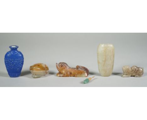 A group of four Chinese jade carvings, comprising; two small recumbent animals, 4cm. and 6cm. length; a snuff bottle in the f