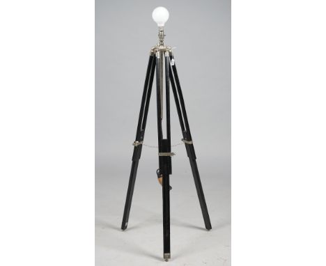 A modern ebonised wood and white metal adjustable floor lamp, raised on adjustable tripod supports with a black shade.