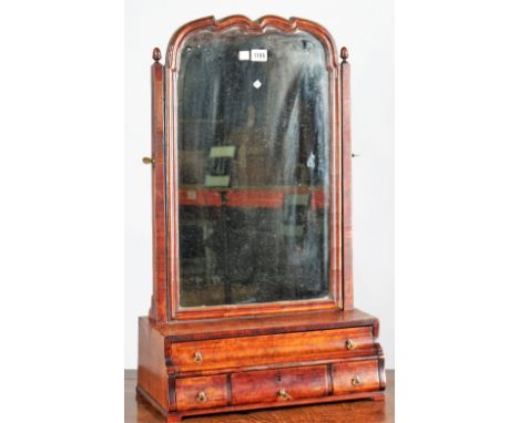 A Queen Anne figured walnut dressing mirror, the shaped plate over a graduated four drawer base, 47cm wide x 78cm high. 