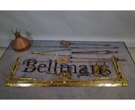An Art Nouveau brass fire fender, 145cm wide x 28cm high and a quantity of brass fire tools, (qty). 
