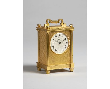 An English giltmetal carriage timepieceCirca 1870The rectangular case with shaped handle and four faceted finials, with engin