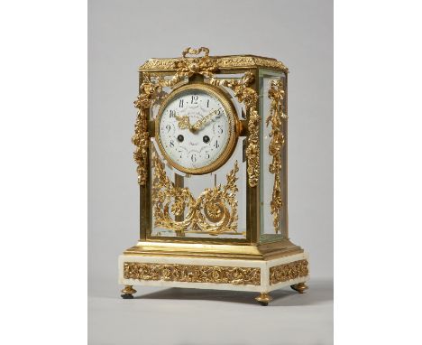 A French ormolu and white marble four glass mantel clockIn the Louis XVI style, circa 1900Th rectangular top with a leaf and 
