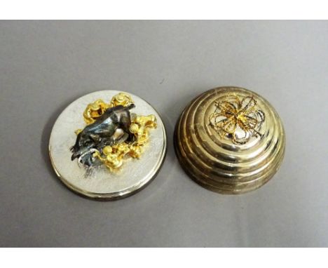 A Stuart Devlin Christmas box, containing a silver and silver gilt model representing the eighth day of Christmas, being Eigh
