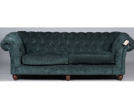 Kirkdale; a modern teal upholstered Chesterfield style sofa on turned supports, 215cm wide x 70cm high. 