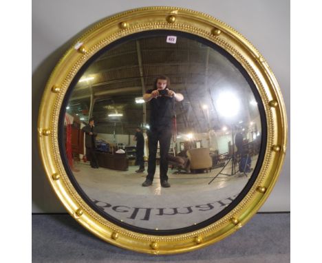 A Regency style giltwood convex mirror, 90cm wide. 