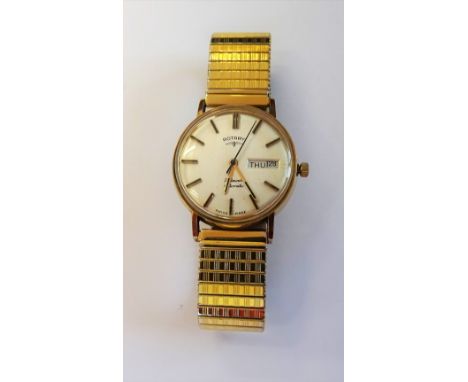 A Rotary Automatic 9ct gold circular cased gentleman's wristwatch, the signed silvered dial with black baton numerals, day of