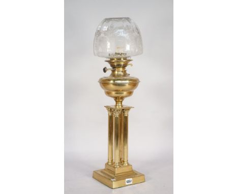 A brass oil lamp, early mid-20th century, of quadruple Corinthian column form on a stepped square base, with later etched gla
