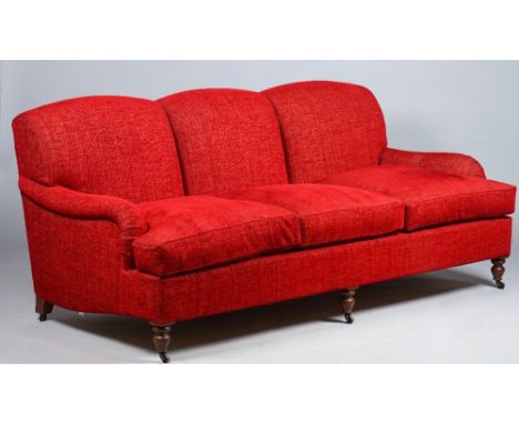 Kingcome Sofas; a modern red upholstered triple hump back sofa on turned supports, 202cm wide x 90cm high. 