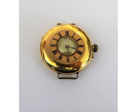 An 18ct gold cased half hunting cased wristwatch, the three quater plate jewelled movement, detailed to the backplate ARMY &a