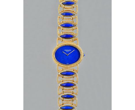 A Patek Philippe gold and lapis lazuli lady's dress bracelet wristwatch, the signed oval plain lapis lazuli dial with ropetwi