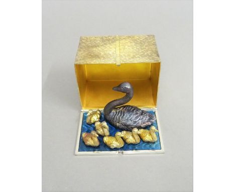 A Stuart Devlin Christmas box, containing a silver gilt, silver and enamelled model representing the seventh day of Christmas