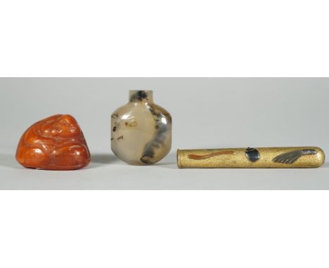 A Chinese agate snuff bottle, 19th/20th century, flattened circular form, in smokey coloured tone with dark brown inclusions,