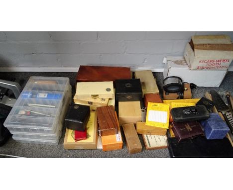 A collection of clockmaker's tools, including a Bergeron mainspring winder;  a bushing tool;  an engineer's level and plate g
