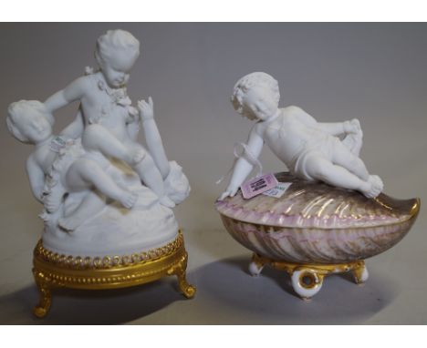 A 20th century bisque figure of three cherubs on gilt metal base and another on a shell base, 15cm high. 
