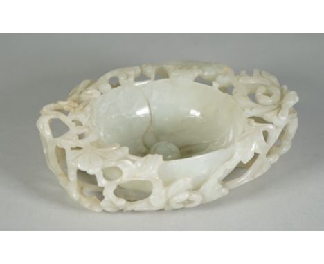 A Chinese pale celadon jade `floral' brush washer, 17th century or possibly later, modelled in the form of a flower with dome