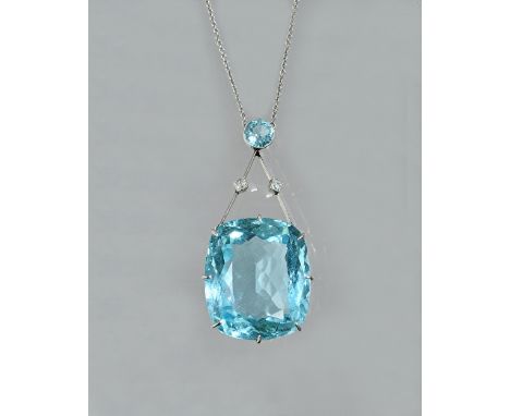 An aquamarine and diamond pendant necklace, claw set with the principal cushion shaped aquamarine to the drop and collet set 