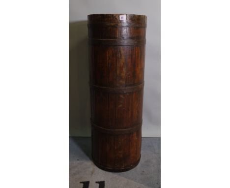 An early 20th century pitch pine and iron bound stick stand of cylindrical form, 32cm diameter x 88cm high. 