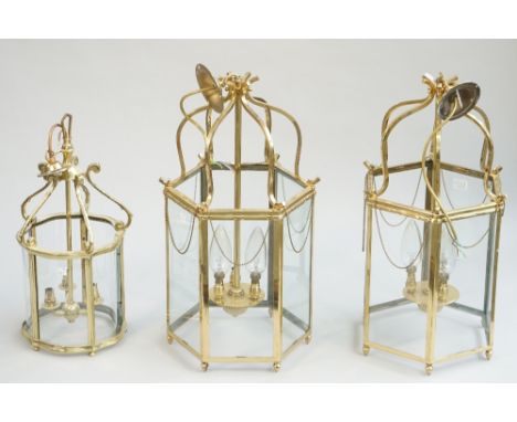 A pair of modern brass hall lanterns of octagonal form, with internal three light fitment, 58cm high and another similar smal