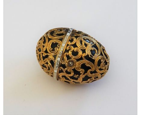 A 19th century gold mounted egg-shaped bloodstone perfume bottle and cover, the scroll cagework casing depicting a hunting sc