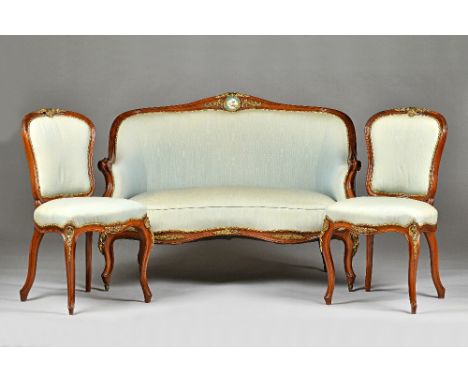 A late 19th century gilt-metal mounted yew wood framed tub back sofa with ceramic plaque inset hump crest over double serpent