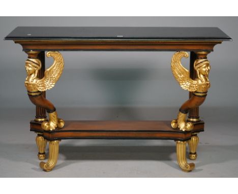 An Empire style console table, the rectangular marble top on a pair of parcel gilt winged caryatids united by concave platfor