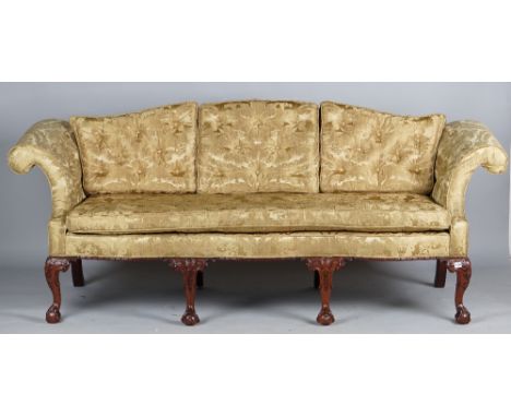 A George II style sofa with hump back, roll over arms and serpentine seat on four claw and ball feet, 220cm wide x 90cm high.