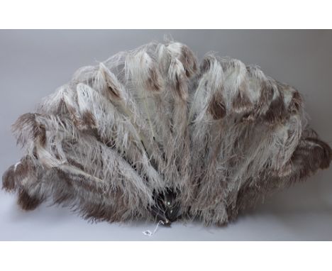 An ostrich feather fan from Sieradzkis, Johannesburg, with tortoiseshell sticks, 62cm, a smaller ostrich feather and mother-o