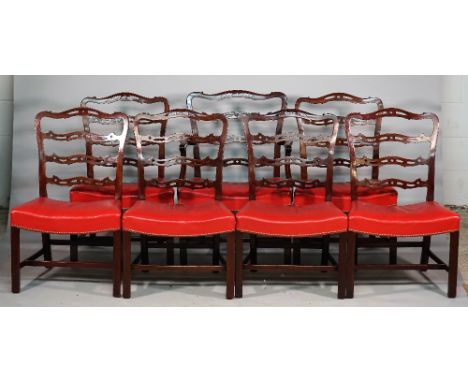 A set of seven George II style mahogany ribbon back dining chairs with concave seat on canted square supports, one carver, (7