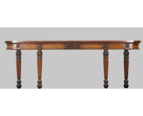 A William IV mahogany console, the shallow 'D' shape top on four foliate carved tapering reeded supports, 272cm wide x 93cm h