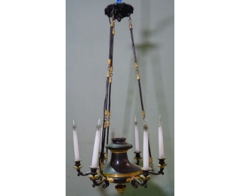 An Empire style gilt and patinated metal six branch chandelier suspended on foliate cast, fluted, linked bars, 100cm high. 