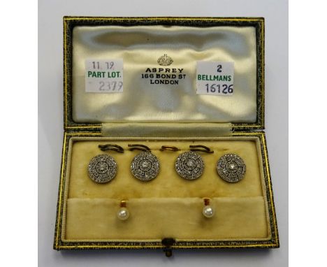 A set of four French platinum and diamond set dress buttons, each collet set with a circular cut diamond to the centre, withi