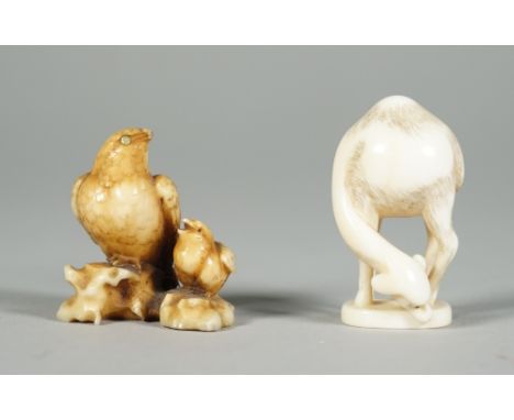A Japanese ivory netsuke of a hawk and young, Edo period, 19th century, perched side by side, the adult with inlaid mother-of