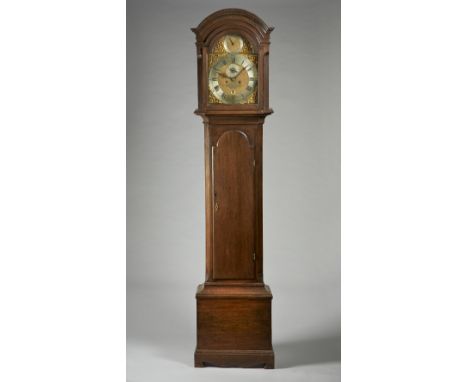 An oak longcase clockThe movement by Thomas Brass, Guildford, circa 1770The case with an arched pediment above glazed door an