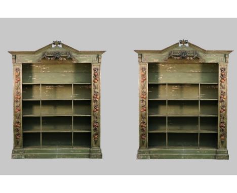 A pair of Baroque revival green painted floor standing open bookcases, the urn mounted broken architectural cornice with poly