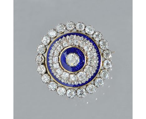 A gold backed and silver set diamond and blue enamelled brooch, of circular form, mounted with the principal cushion shaped d