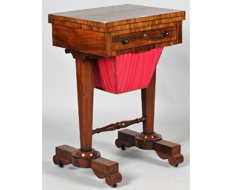 A Regency rosewood work/ games table, the pivoting top revealing a Backgammon board over fitted frieze drawer and wool box on