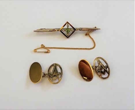 A pair of oval 9ct gold masonic cufflinks, the fronts pierced with square and compasses motifs and a gold, peridot and seed p