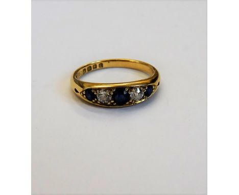 A late Victorian 18ct gold, sapphire and diamond set five stone ring, mounted with three cushion shaped sapphires, alternatin