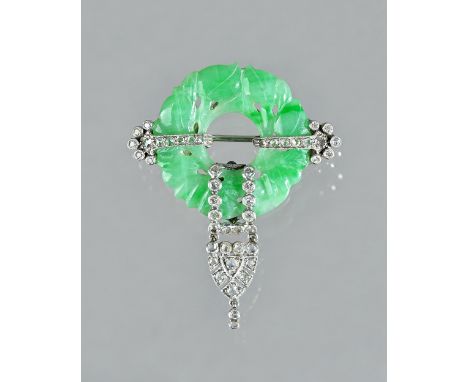 A diamond set and carved jade brooch, circa 1920, formed as a carved and pierced circular jade, decorated with fruit, with a 