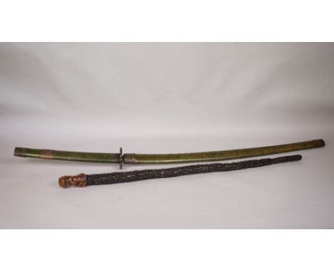 A South East Asian hardwood walking stick, the finial carved as the head of a sage, 82cm and a Japanese Katana sword in a fau