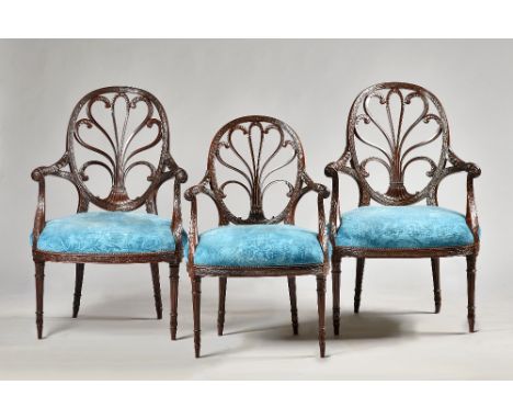 A set of twelve Adam Revival mahogany open armchairs, each with stylized Prince of Wales feathers oval backs and bow seat on 