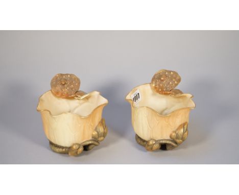 A pair of Royal Worcester blush ivory vases, late 19th century, each of lily pad form with gilt flower and turtle to the rim,