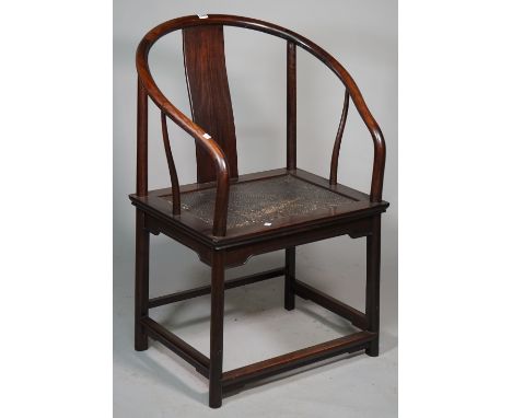 An early 20th century Chinese hardwood horseshoe back armchair with woven seat on rounded supports, 70cm wide x 98cm high. 