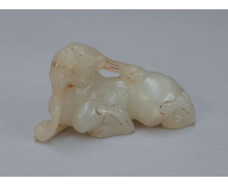 A Chinese small white jade mythical creature, carved in recumbent pose, 5.5cm.length.