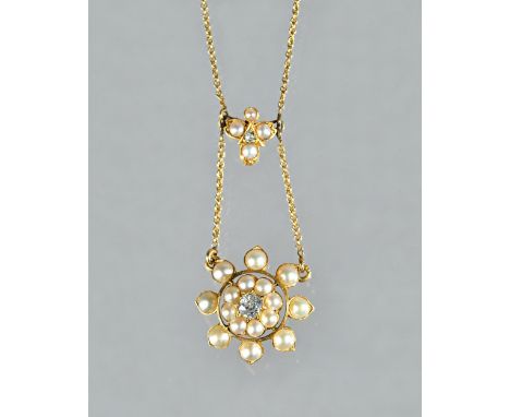 A gold, diamond and half pearl set pendant necklace, circa 1900, the front mounted with a cushion shaped diamond, in a two ro