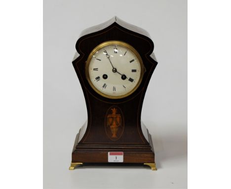 An Edwardian mahogany, box wood strung and satinwood inlaid lancet shaped mantel clock having a convex enamel dial with Roman