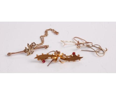 A 9ct gold, ruby and pearl set bar brooch; together with a yellow metal and seed pearl set safety pin bar brooch; sundry yell